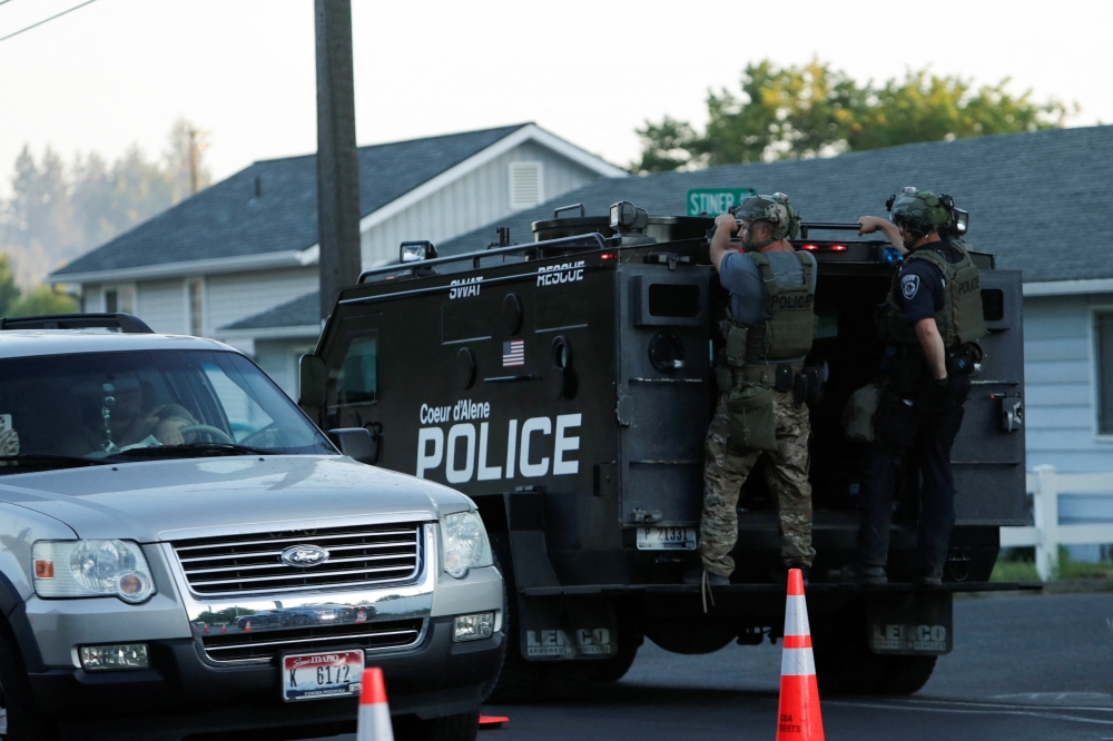An armoured police vehicle leaves an area where multiple firefighters were attacked when responding to a fire in the Canfield Mountain area outside Coeur d’Alene, Idaho, US. — Reuters
