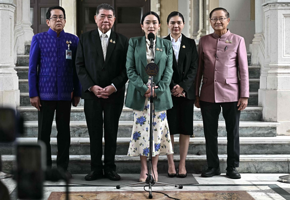 Thailand's Prime Minister Paetongtarn Shinawatra speaks next to Thailand's Deputy Prime Minister Phumtham Wechayachai during a press conference following her suspension by the country's Constitutional Court at Government House in Bangkok. - Reuters  

