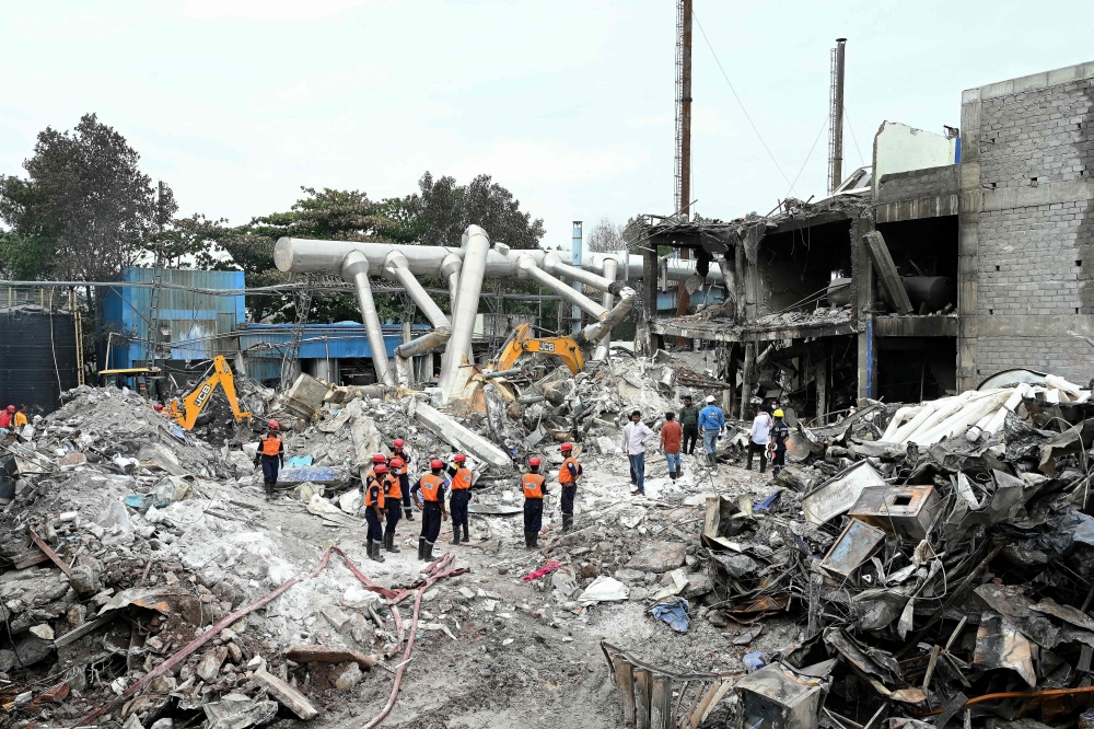 Rescue personnel inspect the debris