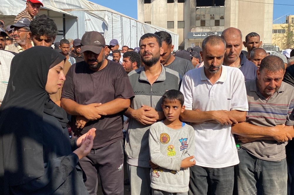 Mourners pray during a funeral of displaced Palestinians,at Khan Yunis' Nasser hospital. — AFP