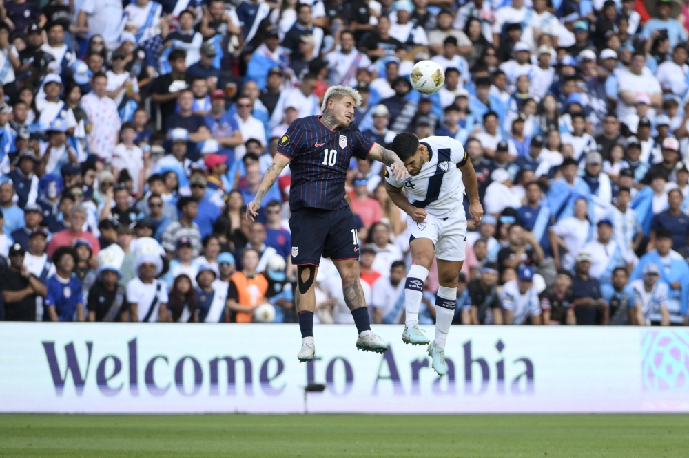 USA midfielder Diego Luna (10) heads the ball against Guatemala defender Jose Pinto (4). — Reuters