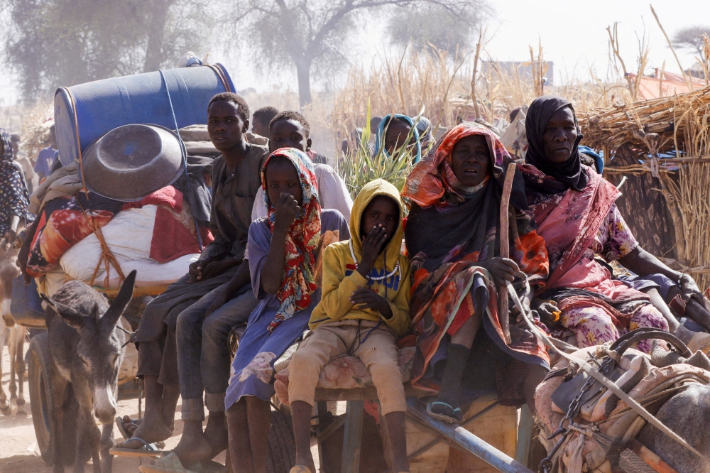 Displaced people ride a an animal-drawn cart, in North Darfur, Sudan. — Reuters