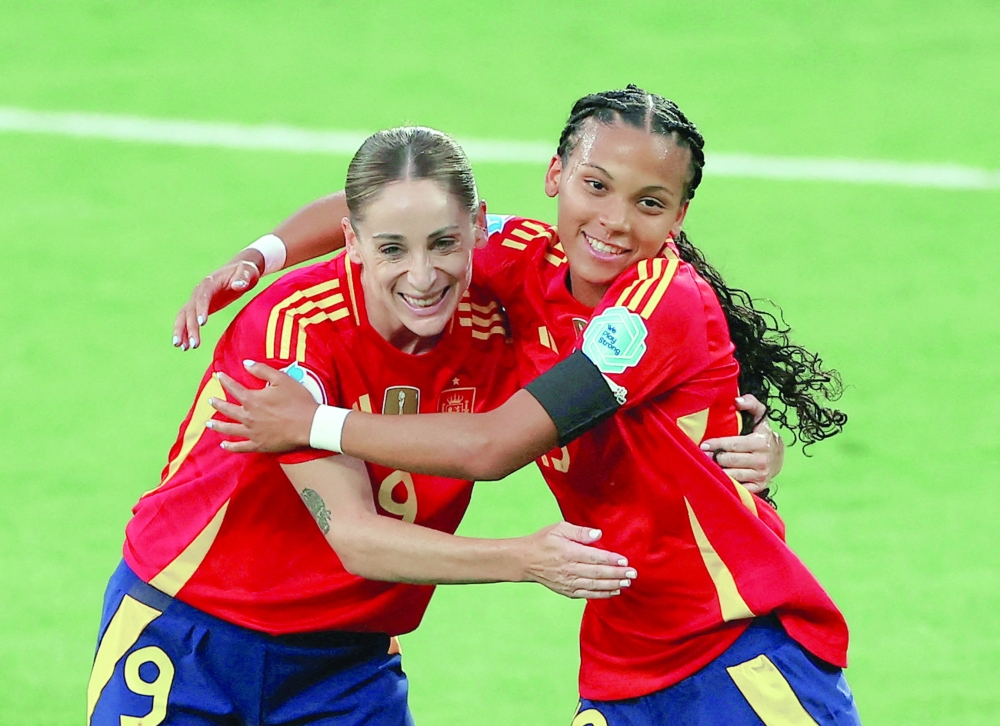 Spain's Vicky celebrates scoring second goal with Esther. — Reuters