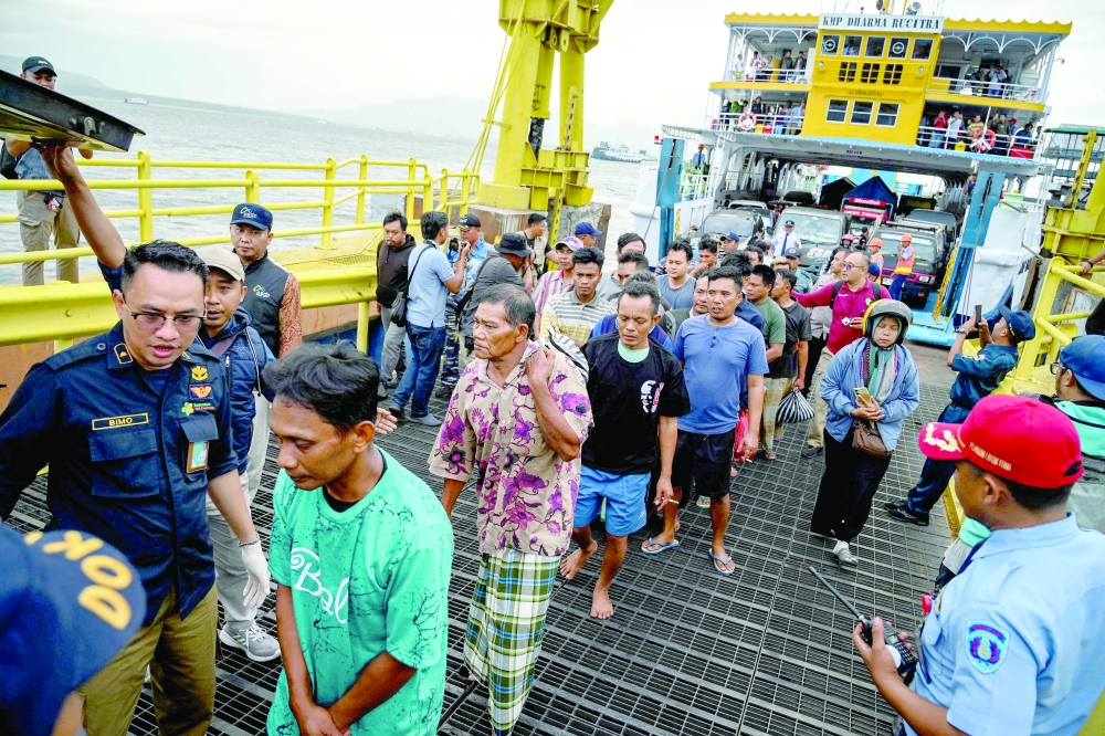 The survivors of the sunken ferry accident arrive at Ketapang port aboard another ferry in Banyuwangi. — AFP