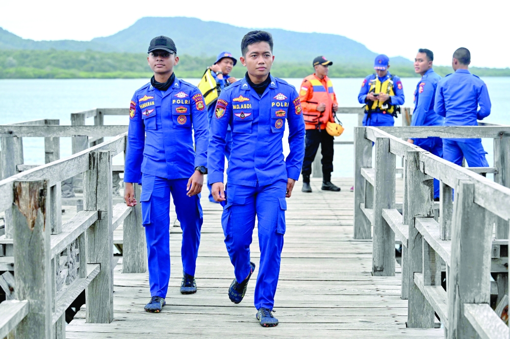 Members of a marine police unit are seen during the search for missing victims, Bali. — AFP