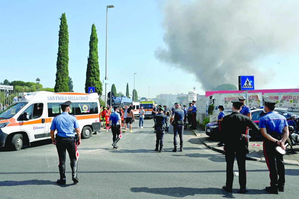 Firemen, policemen and rescue teams work on the site of an explosion in a fuel station in Rome. — AFP