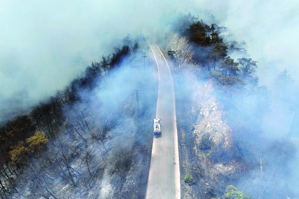 An aerial view shows a fire truck driving down a road