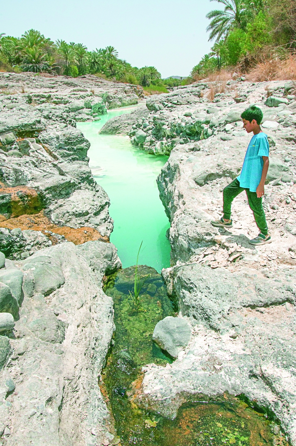 A child stands on the highest side exploring the site.