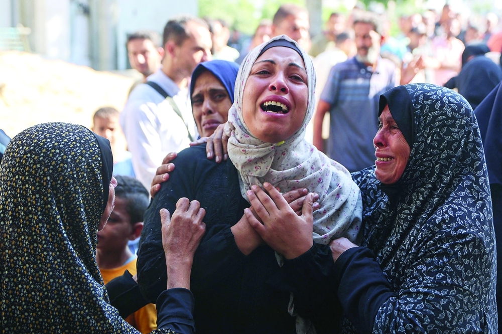 A Palestinian woman mourns a relative outside the Al Shifa hospital in Gaza City. — AFP