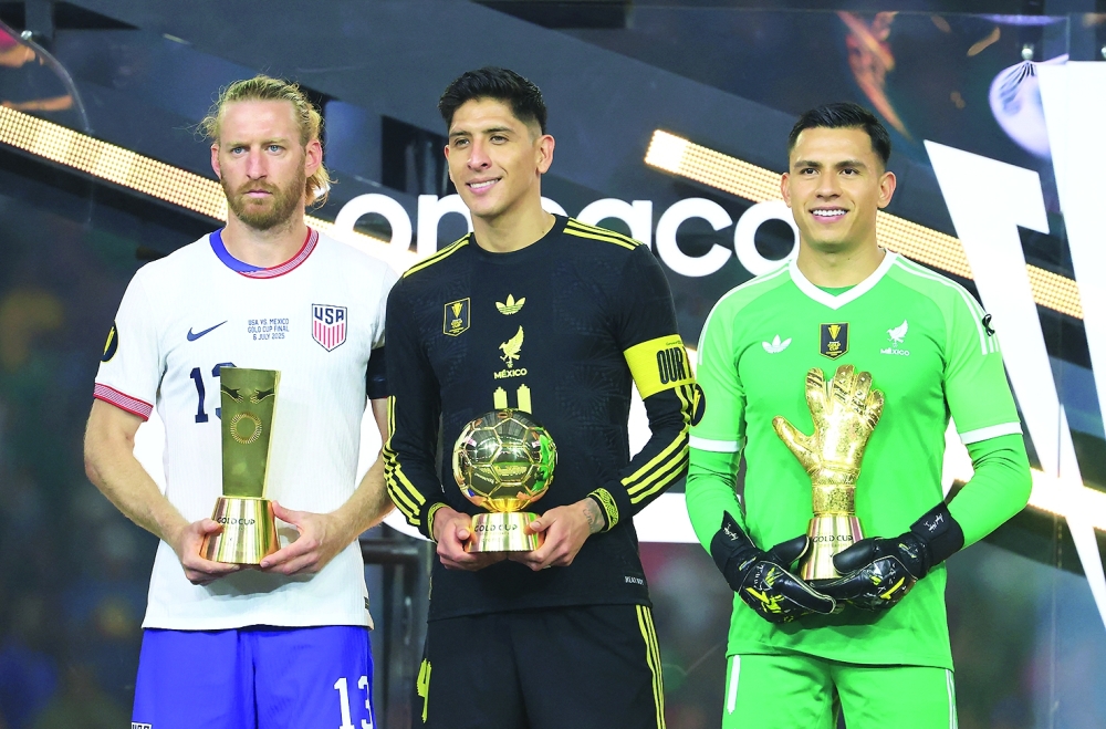 US defender Tim Ream (13), Mexico midfielder Edson Alvarez (4) and Mexico goalkeeper Angel Malagon (1) pose with the fair play, best player, and best goalkeeper awards. — Reuters 