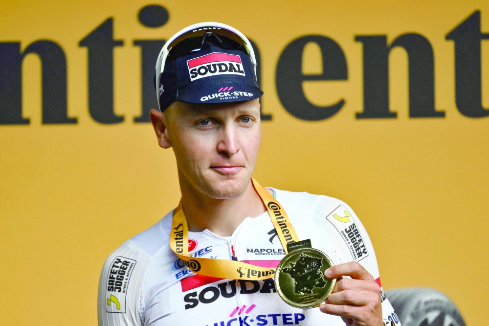 Belgian rider Tim Merlier celebrates on the podium. — AFP