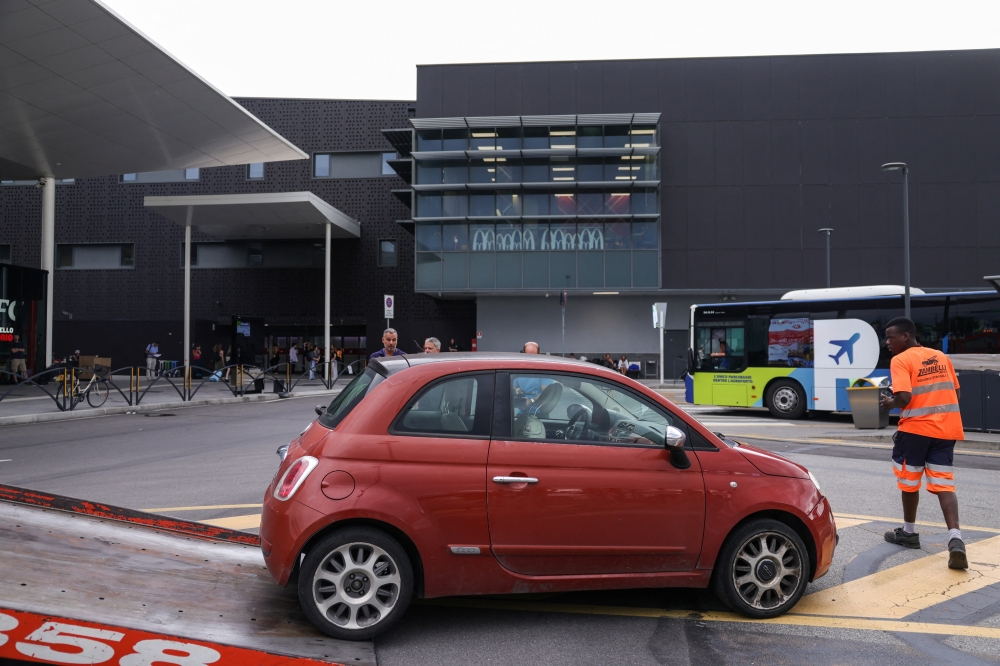 The vehicle of the person, who died during take-off preparations at Milan Bergamo Airport (Il Caravaggio International Airport), is taken away, in Orio al Serio, near Bergamo, Italy, July 8, 2025. REUTERS/Claudia Greco
