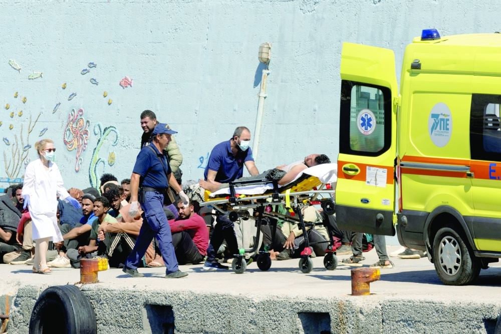 Medics transfer a migrant to an ambulance, after Greece rescued hundreds of migrants off the islands of Gavdos and Crete in separate incidents, according to the Greek Coast Guard, in the port of Agia Galini, Greece. — Reuters