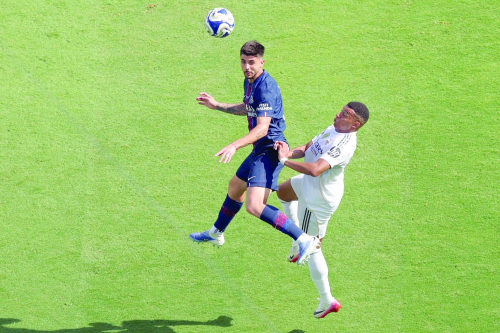 Paris Saint-Germain's Brazilian defender #04 Lucas Beraldo (L) fights for the ball with Real Madrid's French forward #09 Kylian Mbappe. — AFP