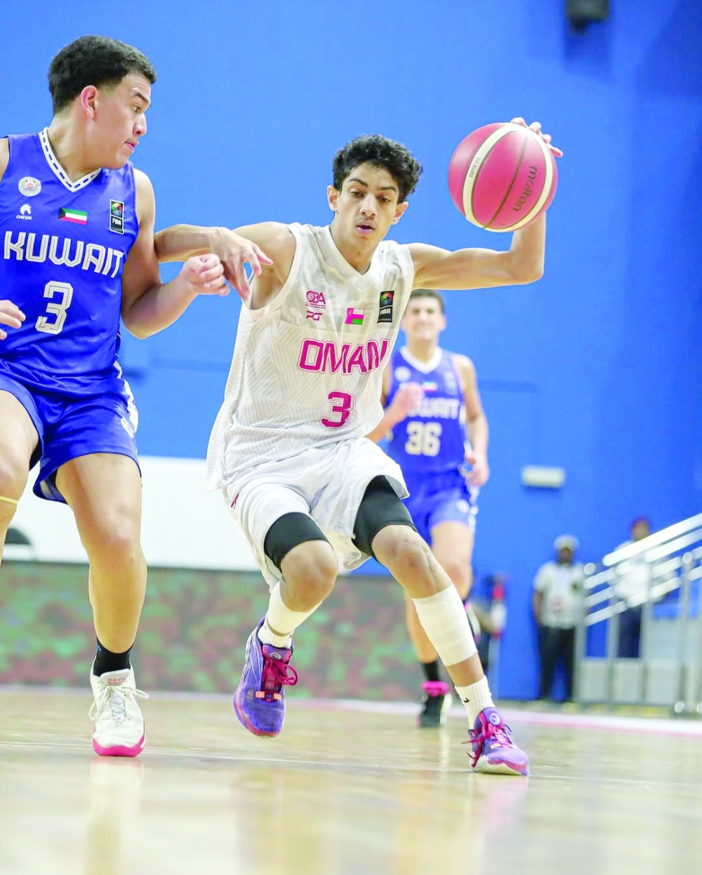 Oman player controls the ball 