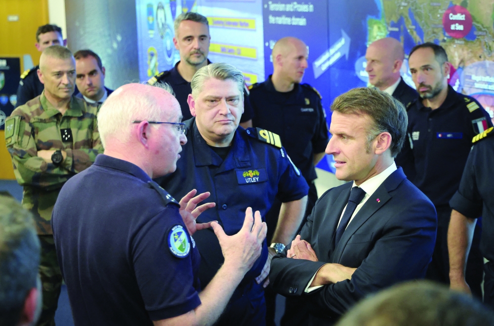 France's President Emmanuel Macron listens to a Nato military officer during a Coalition of the Willing meeting at a military base at Northwood Headquarters in north-west London, Britain. — Reuters