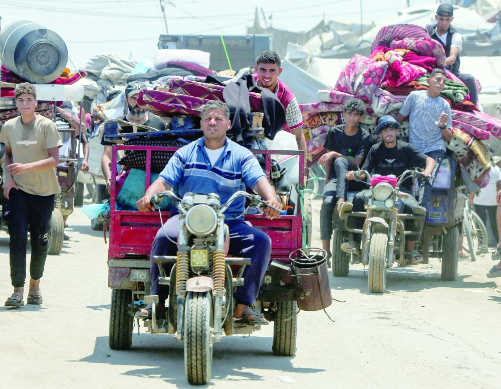 Displaced Palestinians make their way towards Mawasi area as they flee amidst an Israeli ground offensive, in Khan Yunis in the southern Gaza Strip. — Reuters