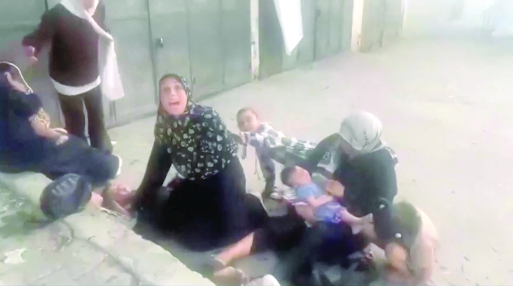 Palestinians react near casualties following an Israeli strike near a medical centre in Deir Al Balah, in the central Gaza Strip, on Thursday. — Reuters