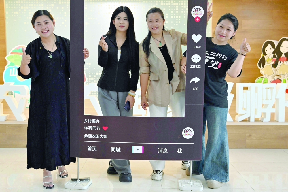 Sisters (L-R) Tian Dongying, Tian Wenxin, Tian Chunying and Tian Junying, livestreamers and e-commerce experts born to farmers who organise monthly training camps for 'new farmers', posing at the rural revitalisation office in Penglai, Yantai city, China's eastern Shandong province. - AFP