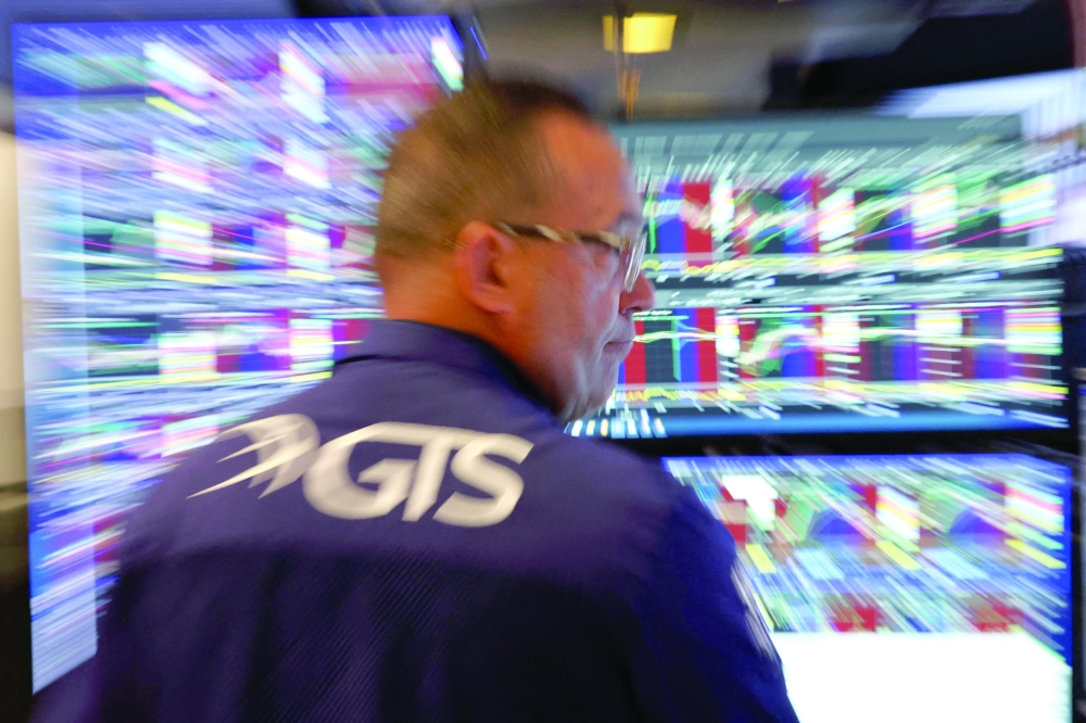 A trader works at his desk on the floor of the New York Stock Exchange at the opening bell in New York. - AFP