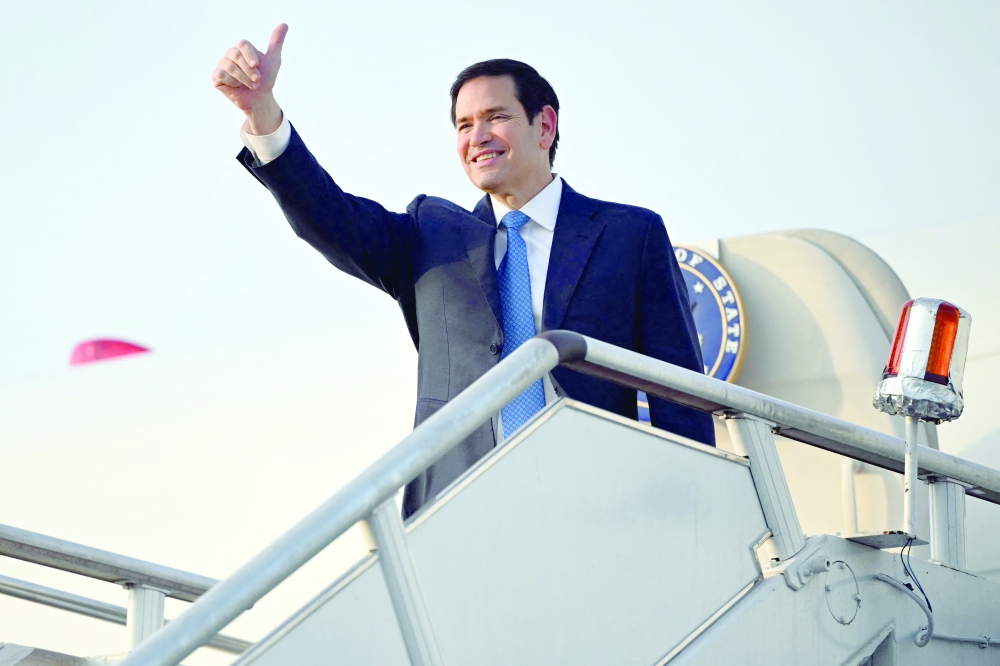 US Secretary of State Marco Rubio gestures as he boards his flight, Kuala Lumpur. — AFP