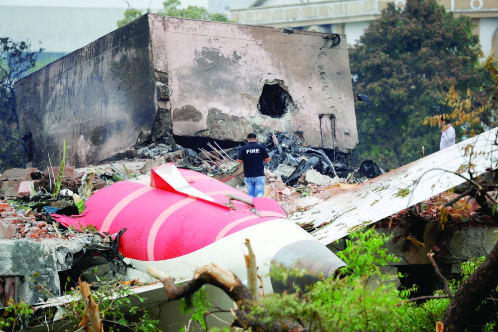 A firefighter stands next to the crashed Air India Boeing 787-8 Dreamliner aircraft, in Ahmedabad, India. — Reuters file photo