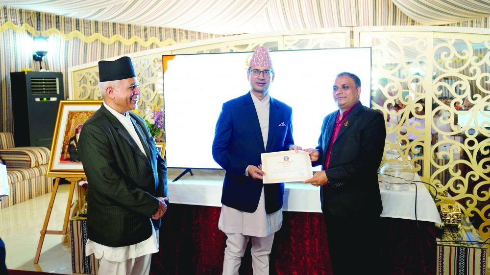 Ambassador Aryal distributes certificate to a participant