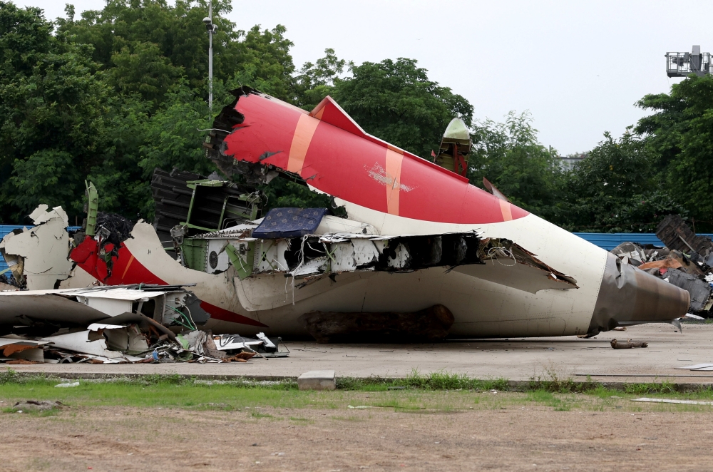 Wreckage of the Air India Boeing 787-8 Dreamliner plane sits on the open ground, outside Sardar Vallabhbhai Patel International Airport,