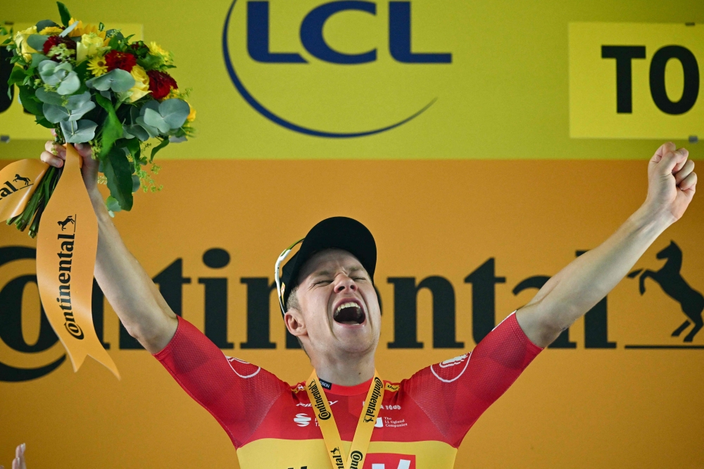 TOPSHOT - Uno-X Mobility team's Norwegian rider Jonas Abrahamsen celebrates on the podium after winning the 11th stage of the 112th edition of the Tour de France cycling race, 156.8 km starting and finishing in Toulouse, southwestern France, on July 16, 2025. (Photo by Loic VENANCE / AFP)

