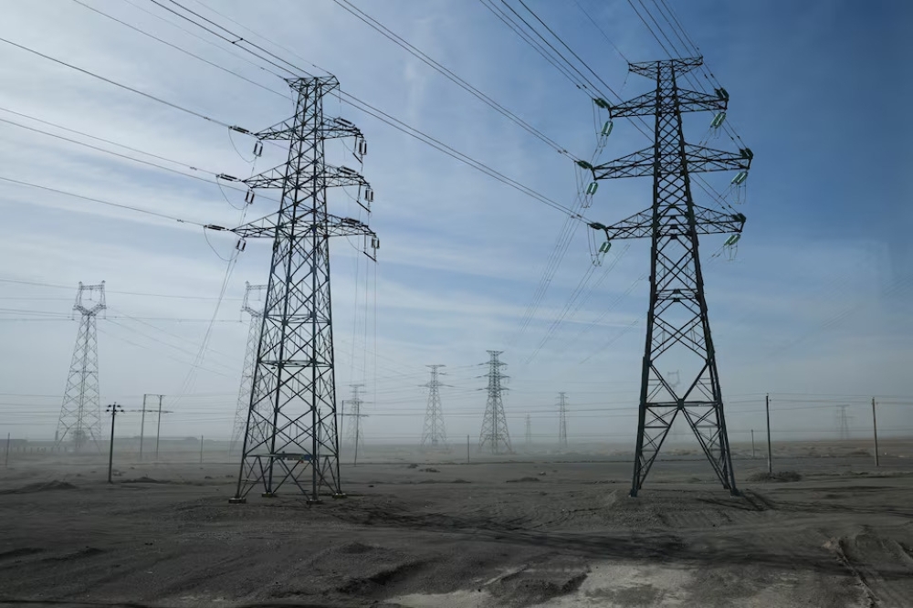 A general view of electricity pylons during an organised media tour in Jiuquan, Gansu province, China. — Reuters