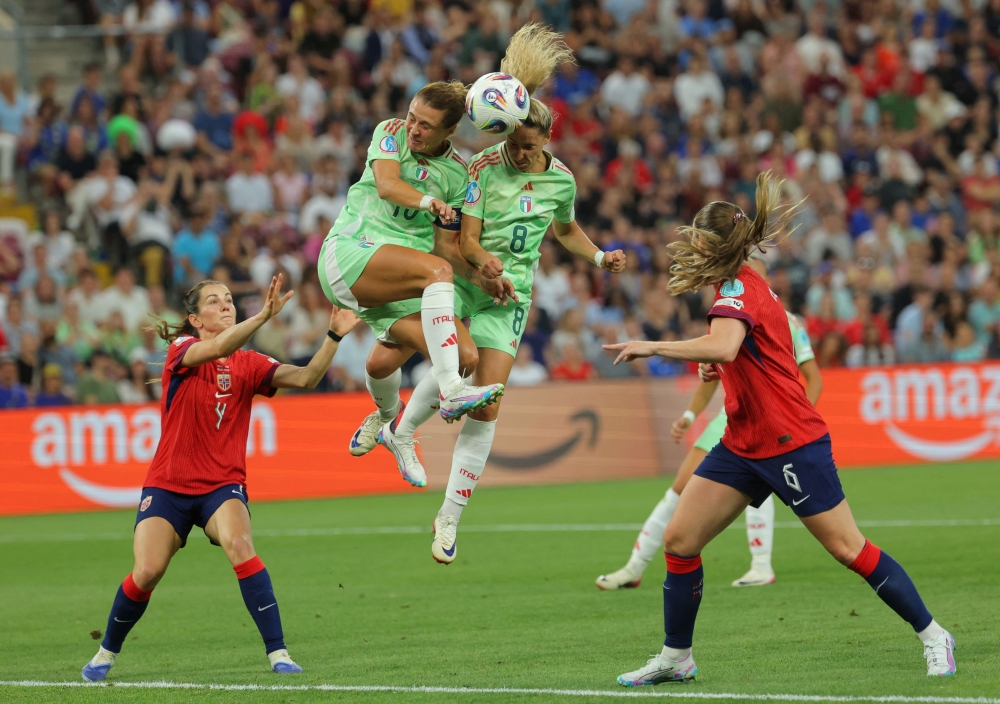 Italy's Cristiana Girelli and Emma Severini in action. —  Reuters