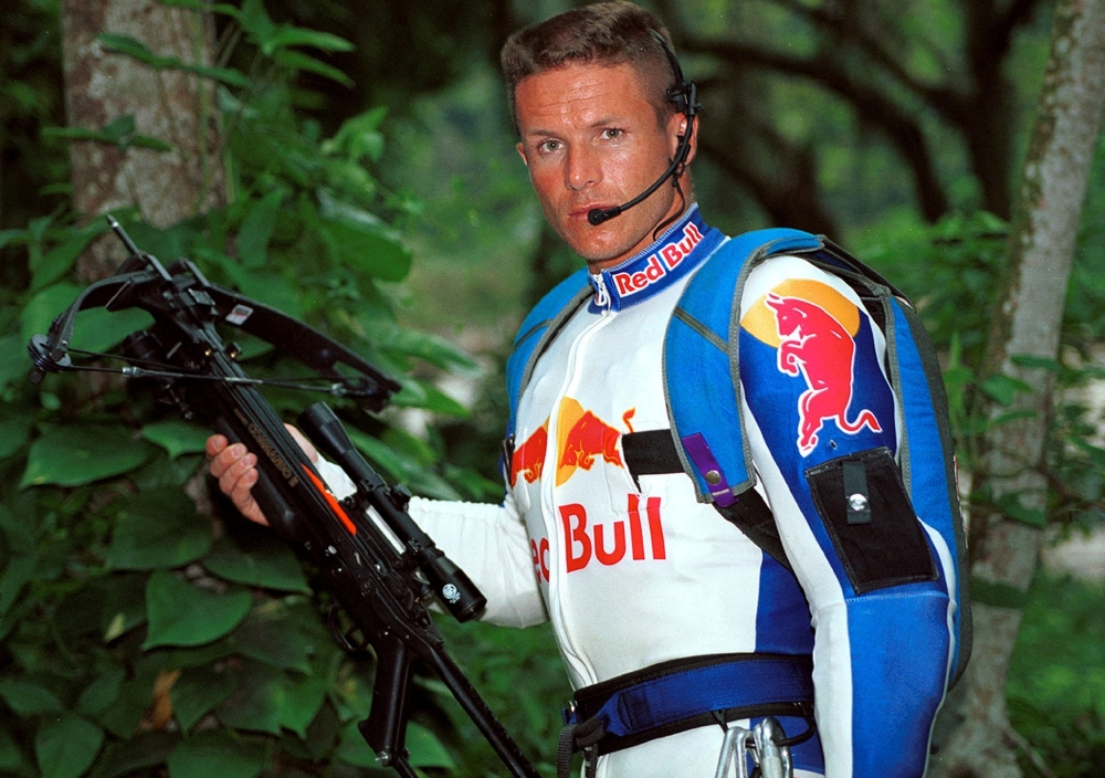 FILE PHOTO: Austrian parachuter Felix Baumgartner, 30-year-old, who goes by the code name "Base 502," poses with the crossbow he used to scale the arm of the Christ the Redeemer statue atop Corcovado mountain, and parachute off, in Rio de Janeiro on December 1. It is the first-ever known base-jump made from the site. In base-jumping, which is illegal in most countries, parachutists jump from buildings, antennae, spans such as bridges and earth points like rocks, and the parachute is only pulled open at the very last moment. Baumgartner camped out overnight at the site and used a high-tech crossbow to shoot a line over the arm of the 30-meter-high statue to climb up. The statue and mountain are located 747 meters above sea level.GN/JP/File Photo