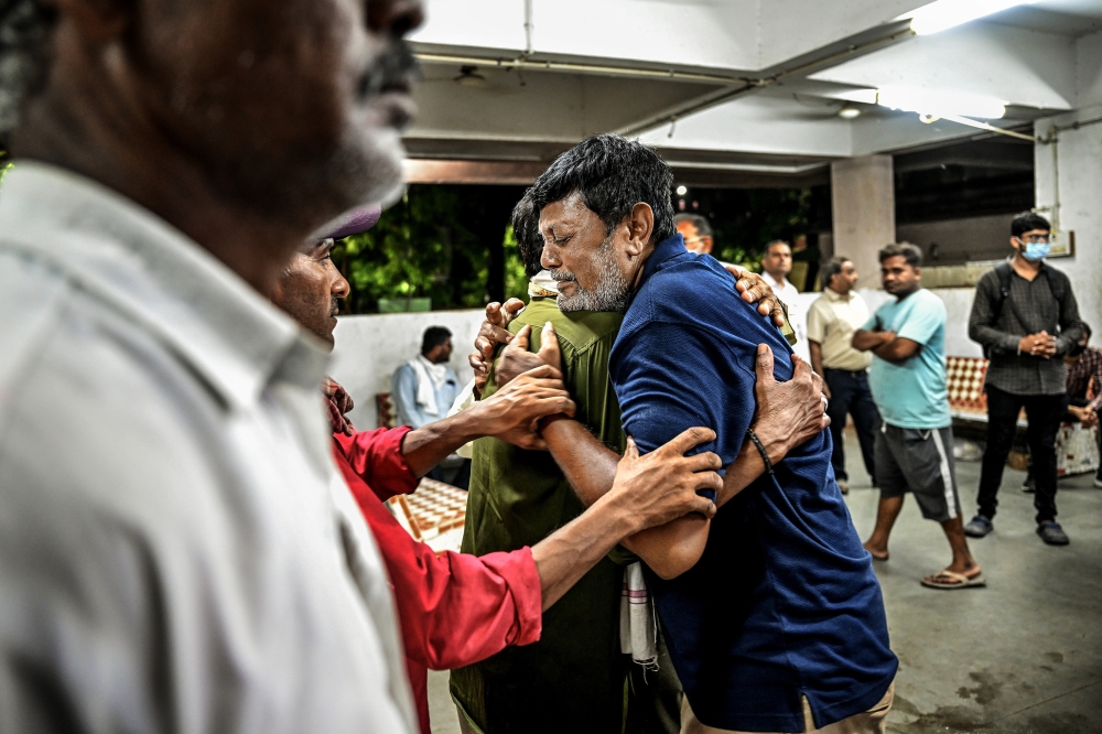 Pooja’s father, Ashok Vamanrao Mate, embraces Anil Ambalal Patel in Ahmedabad, India, June 17, 2025. (Atul Loke/The New York Times)