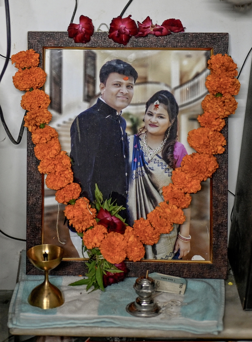 Harshit and Pooja’s photo is displayed in Ahmedabad, India, June 23, 2025. (Atul Loke/The New York Times)