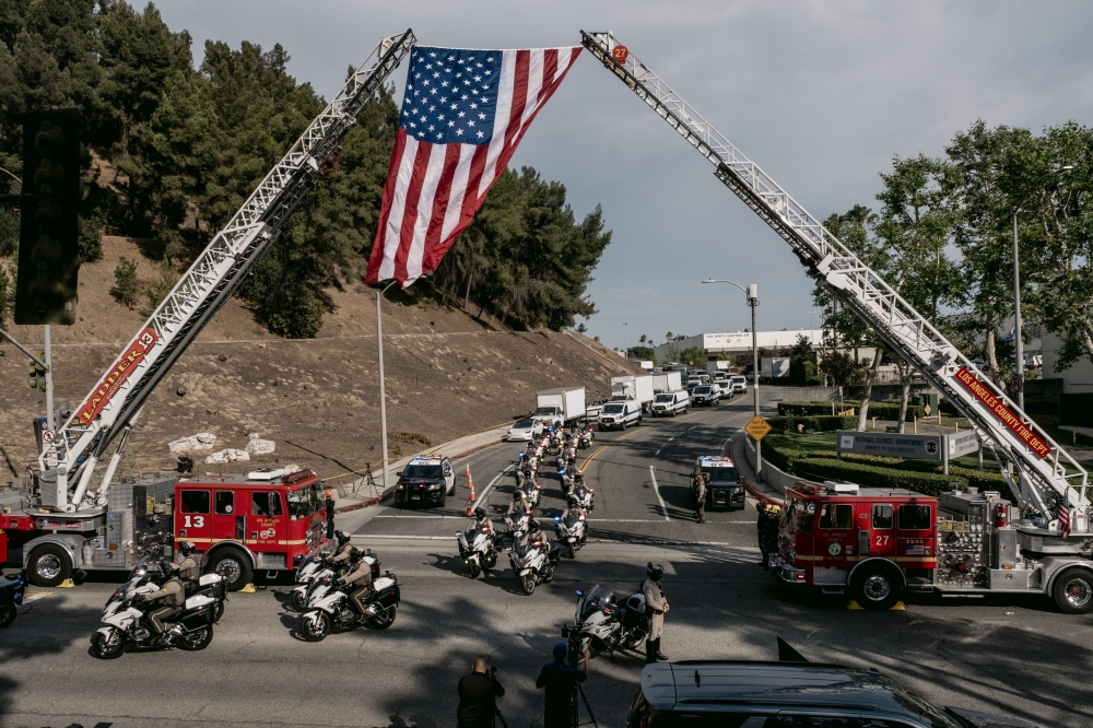 Firefighters and law enforcement officers take part in a procession as the remains of three sheriff’s deputies killed on Friday are removed from the Biscailuz training center of the Los Angeles County Sheriff’s Department in East Los Angeles, on Friday, July 18, 2025. (Mark Abramson/The New York Times)