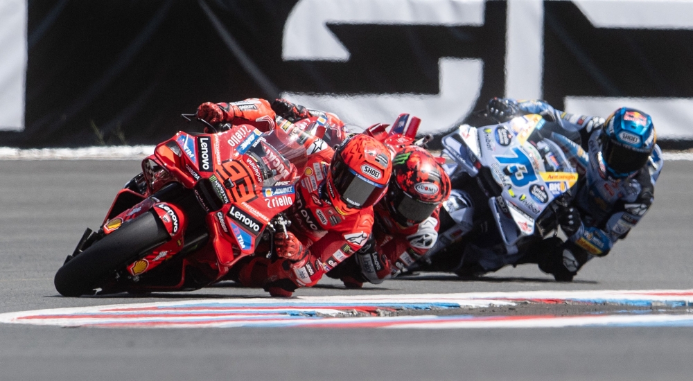 Marquez (1st L) followed by Francesco compete during the qualifying. — AFP
