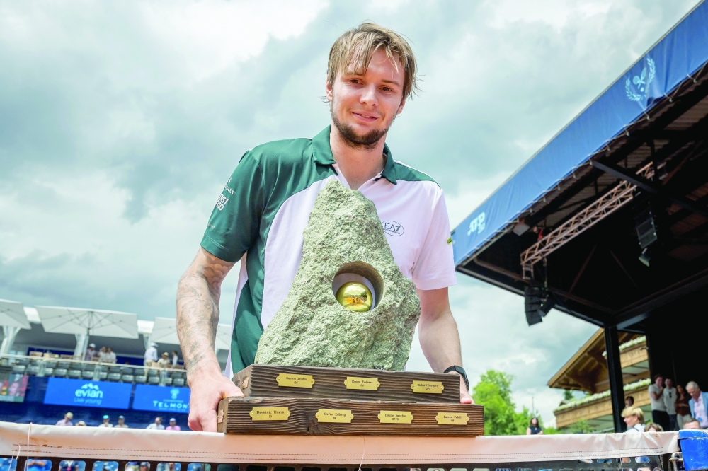 Kazakhstan's Alexander Bublik poses with the trophy after winning the men's singles final match against Argentina's Juan Manuel Cerundolo. — AFP