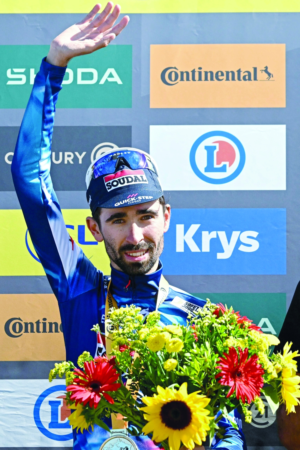 Soudal Quick-Step team's French rider Valentin Paret-Peintre celebrates on the podium after winning the 16th stage. — AFP