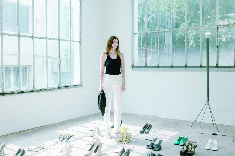 Footwear designer Nina Christen with a collection of her shoes and prototypes at her home studio in Paris, June 26, 2025. (Dmitry Kostyukov/The New York Times)