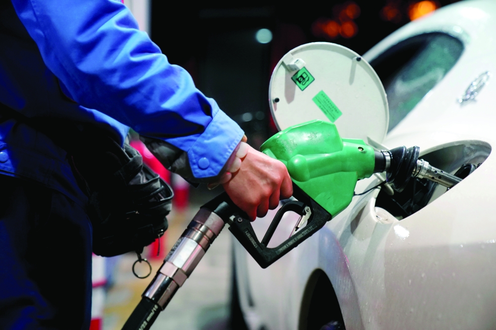 
A gas station attendant pumps fuel into a customer’s car at a gas station. — Reuters 