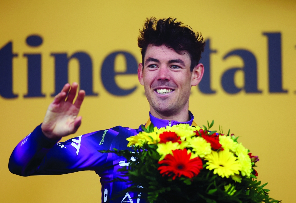Team Jayco AlUla's Ben O'Connor celebrates on the podium after winning stage 18. — Reuters