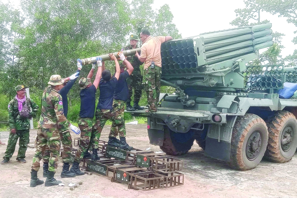
Cambodian soldiers reload the BM-21 multiple rocket launcher in Preah Vihear province. — AFP 