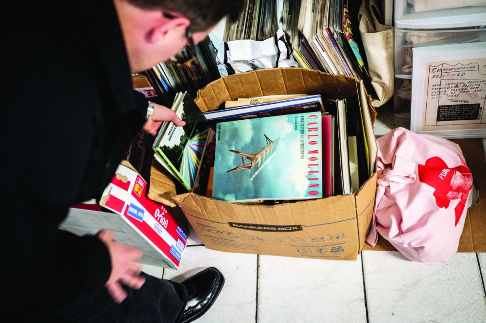 Geoff Snack, a vintage and rare book dealer, rummages through a box of books for display in the Colbo menswear store, in Manhattan.