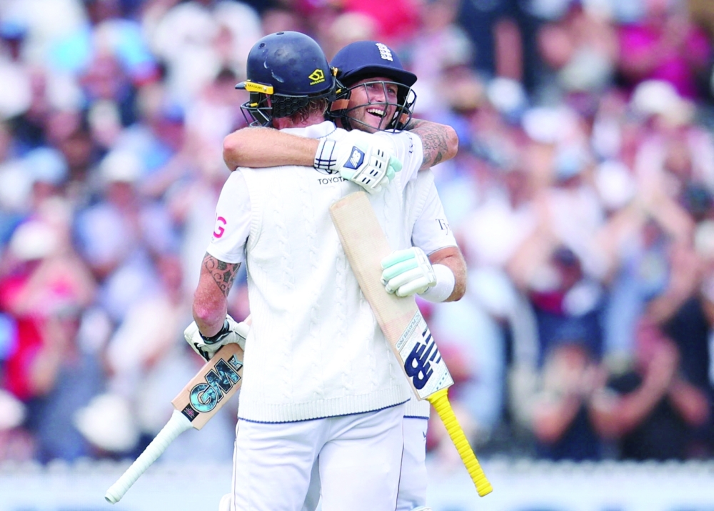 England's Root celebrates after reaching his century with Ben. — Reuters