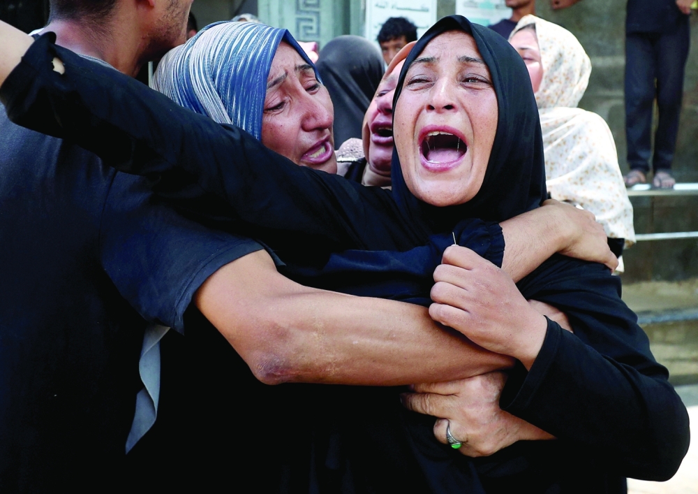 
Mourners react at the funeral of Palestinians killed in an Israeli strike on a school sheltering displaced people, according to the medics, at Al Shifa Hospital in Gaza City. — Reuters 