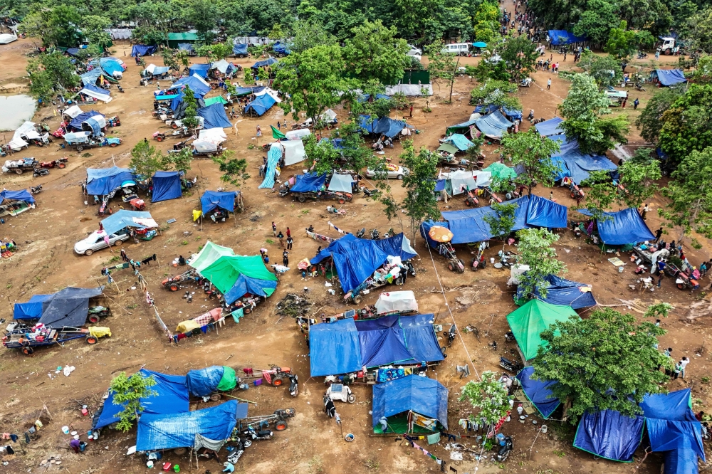 
An aerial view shows people taking shelter near a pagoda in Oddar Meanchey province. — AFP 