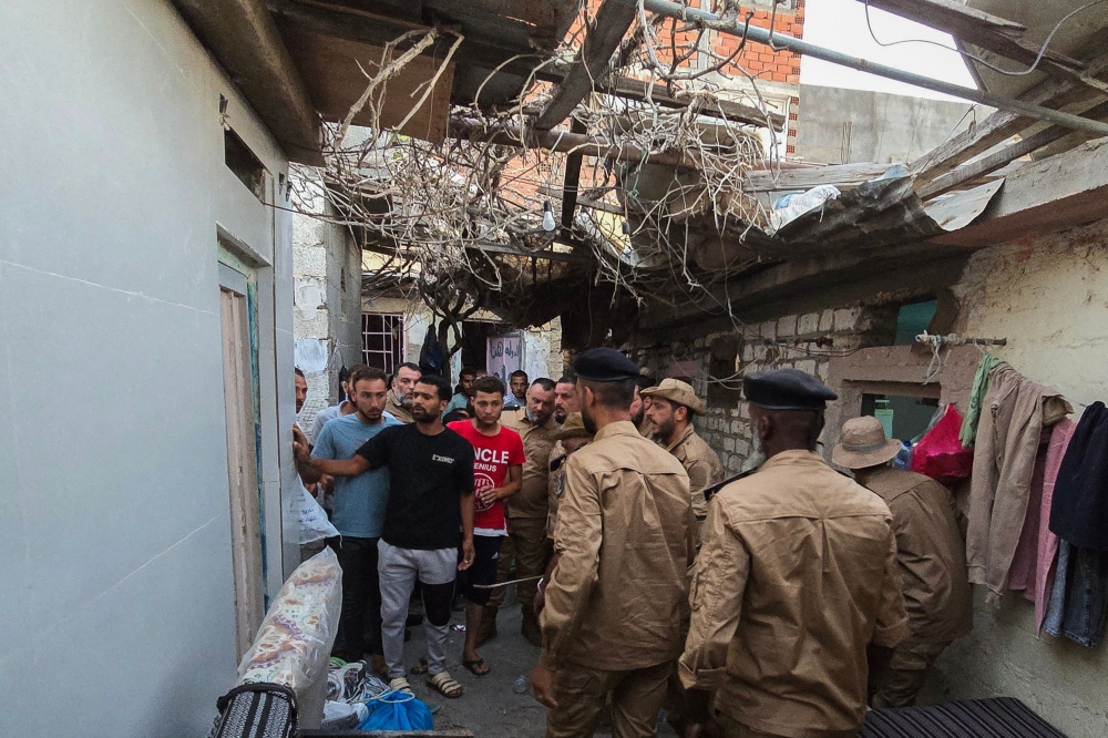 
Members of Libya’s Anti-Illegal Immigration Agency conduct a raid, in Tripoli. — AFP 