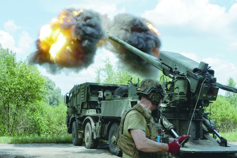 Service members fire a self-propelled howitzer towards Russian troops, in Kharkiv. — Reuters 