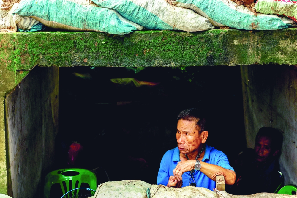 A man looks on inside a bunker as Cambodia and Thailand each said the other had launched artillery attacks. — Reuters 