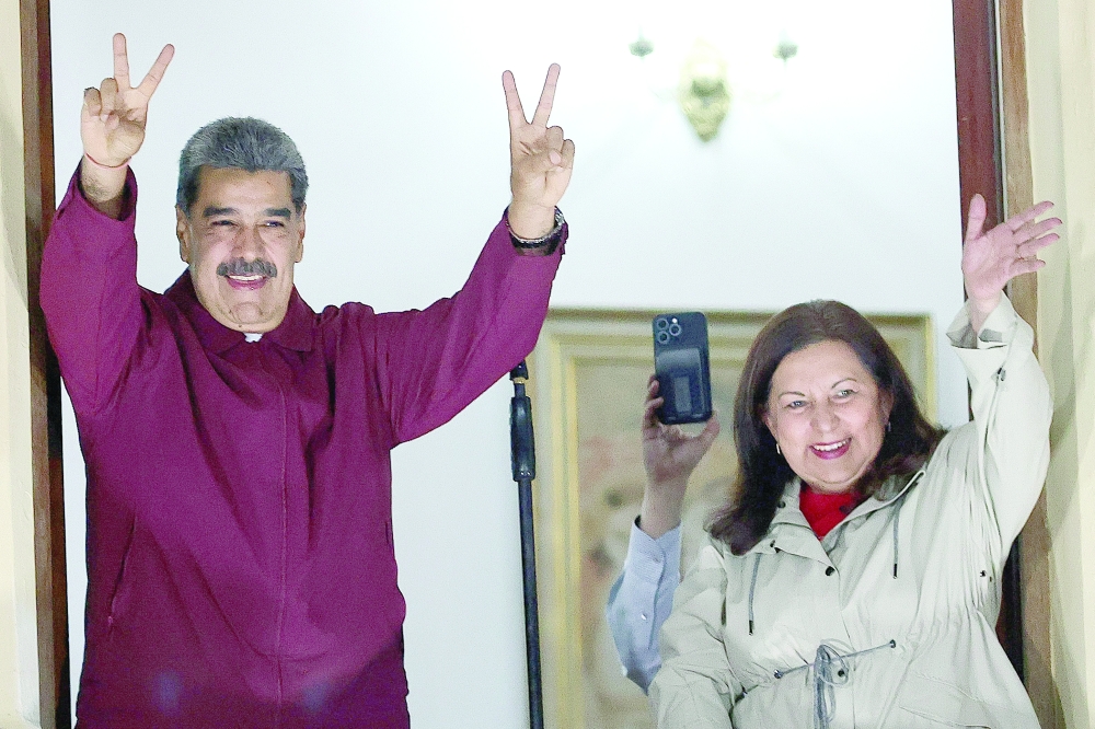 Venezuelan president Nicolas Maduro and Caracas mayor Carmen Melendez gesture to the crowd after results were released in Caracas. — AFP